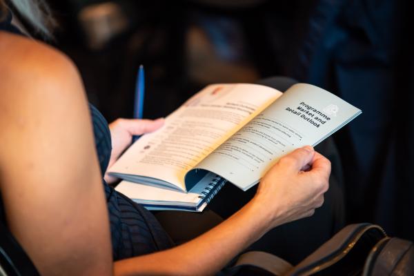 A Global Shrimp Forum 2022 attendee reading the programme