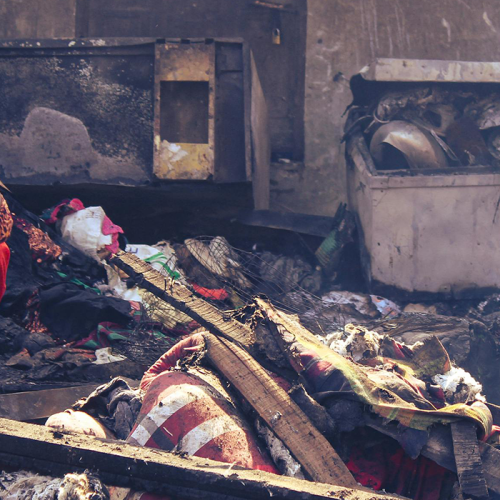 An elderly woman among ruins in Bangladesh